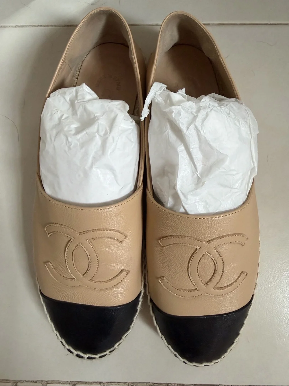 CHANEL Beige Leather Flats with Black Cap Toe and Embossed CC